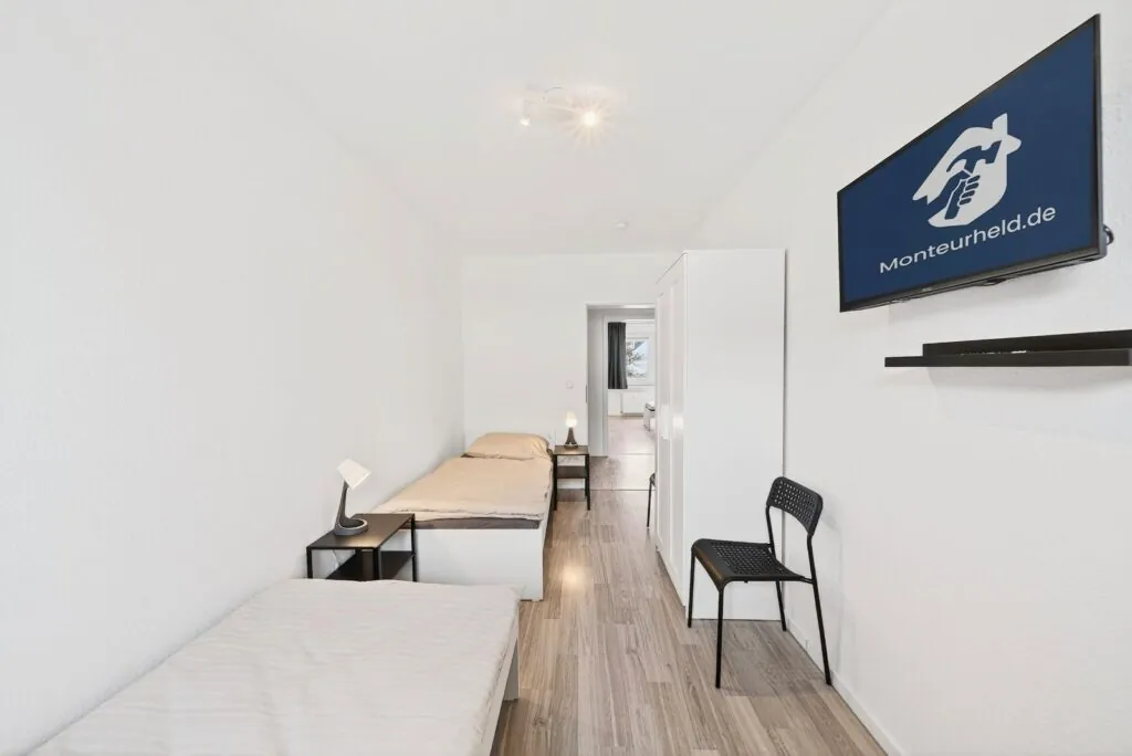 Schlafzimmer mit Einzelbetten und TV – Monteurzimmer Solingen